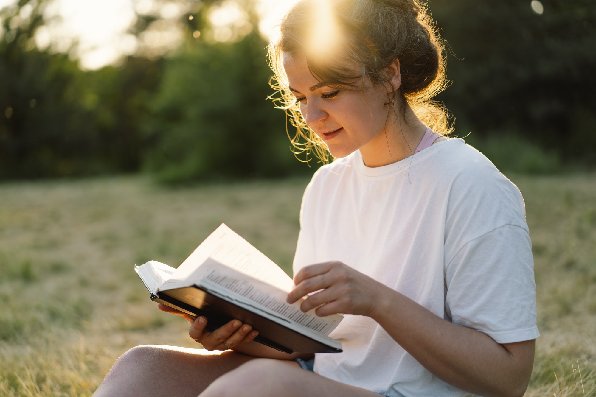 Christian woman holds bible in her hands.
